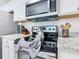 The kitchen features modern appliances and granite countertops at 2781 Almaton Loop # 203, Kissimmee, FL 34747