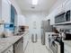 Well-lit kitchen featuring stainless steel appliances, granite countertops, and ample cabinet space at 2781 Almaton Loop # 203, Kissimmee, FL 34747