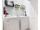 Bright laundry room featuring a Whirlpool washer, dryer, and overhead storage shelving at 2781 Almaton Loop # 203, Kissimmee, FL 34747