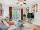 Comfortable living room with sliding glass doors to balcony, ceiling fan, and entertainment center at 2781 Almaton Loop # 203, Kissimmee, FL 34747
