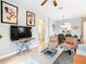 View of the living room with entertainment center, dining area with seating for six, and hallway at 2781 Almaton Loop # 203, Kissimmee, FL 34747