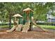 Community playground with multiple slides, climbing structures, and shady trees at 2781 Almaton Loop # 203, Kissimmee, FL 34747