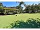 Community putting green with a covered picnic area for relaxing and enjoying the outdoors at 2781 Almaton Loop # 203, Kissimmee, FL 34747