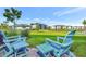 Inviting backyard area with Adirondack chairs, a lush lawn, and views of the resort's buildings at 3205 Caribbean Soul Dr, Kissimmee, FL 34747