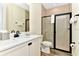 Modern bathroom with a single sink vanity, and walk-in shower and neutral color palette at 3205 Caribbean Soul Dr, Kissimmee, FL 34747