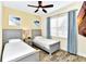 Comfortable bedroom with two twin beds, stylish furnishings, and a relaxing ambiance at 3205 Caribbean Soul Dr, Kissimmee, FL 34747