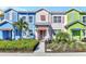 Charming townhomes featuring brightly painted exteriors with manicured landscaping and welcoming front porches at 3205 Caribbean Soul Dr, Kissimmee, FL 34747