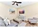 Cozy living room with comfortable seating, stylish décor, and a mounted flatscreen TV for entertainment at 3205 Caribbean Soul Dr, Kissimmee, FL 34747