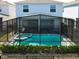 Aerial view of a fenced-in pool in the backyard of a light blue two-story home at 3273 Lilac Way, Davenport, FL 33897