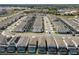 Aerial view of a residential community featuring uniform two-story homes and solar panels at 3273 Lilac Way, Davenport, FL 33897