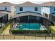 Aerial view of a fenced-in pool in the backyard of a light blue two-story home at 3273 Lilac Way, Davenport, FL 33897