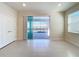 Bright room with sliding glass doors opening to a screened-in patio and swimming pool at 3273 Lilac Way, Davenport, FL 33897