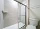 Close-up of bathroom shower with glass door and chrome fixtures at 3273 Lilac Way, Davenport, FL 33897