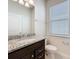 Bathroom with granite countertop, sink, and toilet near window, bright and modern at 3273 Lilac Way, Davenport, FL 33897