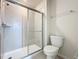 Bright bathroom shower with glass door and chrome fixtures at 3273 Lilac Way, Davenport, FL 33897