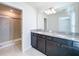 Bathroom features a double sink vanity with granite countertop and tiled shower at 3273 Lilac Way, Davenport, FL 33897