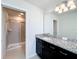 Bathroom features a sink with granite countertop and a tiled shower at 3273 Lilac Way, Davenport, FL 33897