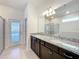 Elegant bathroom featuring double sinks, granite countertop, and a glass-enclosed shower at 3273 Lilac Way, Davenport, FL 33897