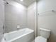 Bathroom featuring white subway tile, a shower and bath combination, and a modern toilet at 3273 Lilac Way, Davenport, FL 33897