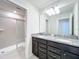 Bathroom featuring double vanity, granite countertops, and glass-enclosed shower at 3273 Lilac Way, Davenport, FL 33897