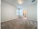 Spacious bedroom with neutral carpet, a window, and an ensuite bathroom entrance at 3273 Lilac Way, Davenport, FL 33897