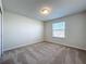 Bedroom with neutral walls, carpeted floors, large window, and bright natural light at 3273 Lilac Way, Davenport, FL 33897