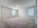 Large bedroom with neutral walls and carpeting and two windows for natural light at 3273 Lilac Way, Davenport, FL 33897