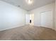Bedroom with neutral carpet and walk-in closet; ensuite bathroom entrance at 3273 Lilac Way, Davenport, FL 33897