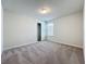 A bright bedroom features neutral carpeting, a closet, and a window for natural light at 3273 Lilac Way, Davenport, FL 33897
