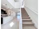 Inviting entry area with staircase, tiled floors, and open layout to the kitchen and living spaces at 3273 Lilac Way, Davenport, FL 33897