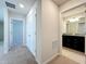 Hallway leading to a bathroom with granite countertops and a spacious bedroom at 3273 Lilac Way, Davenport, FL 33897