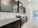 Close up of kitchen features stainless steel appliances and dark cabinets at 3273 Lilac Way, Davenport, FL 33897