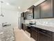 Granite countertops, stainless steel appliances, and dark cabinets complete this modern kitchen at 3273 Lilac Way, Davenport, FL 33897