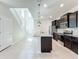 Modern kitchen with granite countertops, stainless steel appliances, and a large island with pendant lighting at 3273 Lilac Way, Davenport, FL 33897