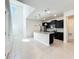 Modern kitchen with granite countertops, stainless steel appliances, and a large island with pendant lighting at 3273 Lilac Way, Davenport, FL 33897
