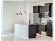 Close-up of kitchen island featuring stainless steel appliances and dark cabinets at 3273 Lilac Way, Davenport, FL 33897