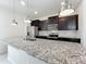Kitchen island with pendant lighting and stainless steel appliances at 3273 Lilac Way, Davenport, FL 33897