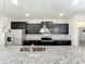 Modern kitchen featuring stainless steel appliances, granite countertops, and pendant lighting at 3273 Lilac Way, Davenport, FL 33897