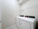 Laundry room with white washer and dryer in a new home at 3273 Lilac Way, Davenport, FL 33897