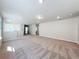 Large, open upstairs loft space with neutral carpet and multiple windows for natural light at 3273 Lilac Way, Davenport, FL 33897