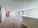 Expansive upstairs loft area with neutral carpet and natural light from several windows at 3273 Lilac Way, Davenport, FL 33897