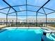 The screened-in pool and spa offers a refreshing escape with privacy and beautiful views at 3273 Lilac Way, Davenport, FL 33897