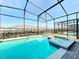 Screened-in pool and spa with brick pavers provides the perfect backyard for relaxation and entertaining at 3273 Lilac Way, Davenport, FL 33897