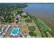 Aerial view of waterfront community amenities include pool, parks, pier and lush greenery at 383 Floral Dr, Winter Garden, FL 34787