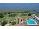Aerial view of park featuring a community pool, pond, pier, and well-maintained green spaces at 383 Floral Dr, Winter Garden, FL 34787