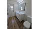 Bathroom featuring white vanity, lighting, mirror and door to the outside at 383 Floral Dr, Winter Garden, FL 34787