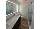 Modern bathroom with double sinks, sleek vanity, illuminated mirror, and marble shower at 383 Floral Dr, Winter Garden, FL 34787