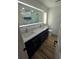 Modern bathroom with double sinks, sleek vanity, illuminated mirror, and marble shower at 383 Floral Dr, Winter Garden, FL 34787