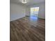 Bedroom boasts hardwood flooring and a sliding glass door leading to a patio at 383 Floral Dr, Winter Garden, FL 34787