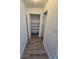Hallway linen closet offers storage with white shelving and bifold doors at 383 Floral Dr, Winter Garden, FL 34787